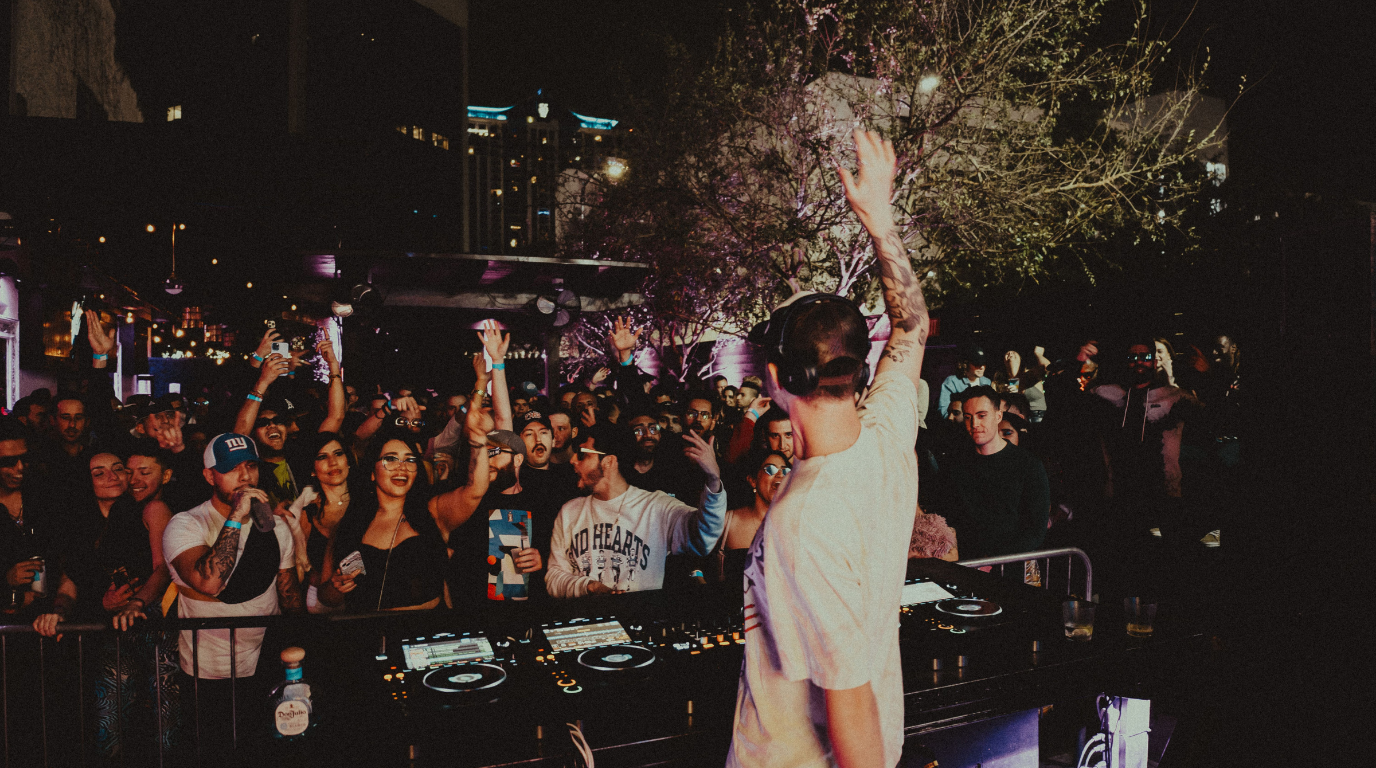 DJ performing a hybrid live set at a festival with visual production