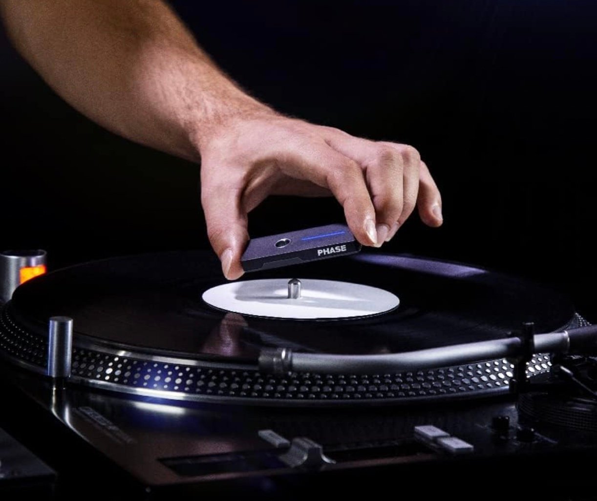 A DJ placing a Phase Remote onto a record on a turntable platter